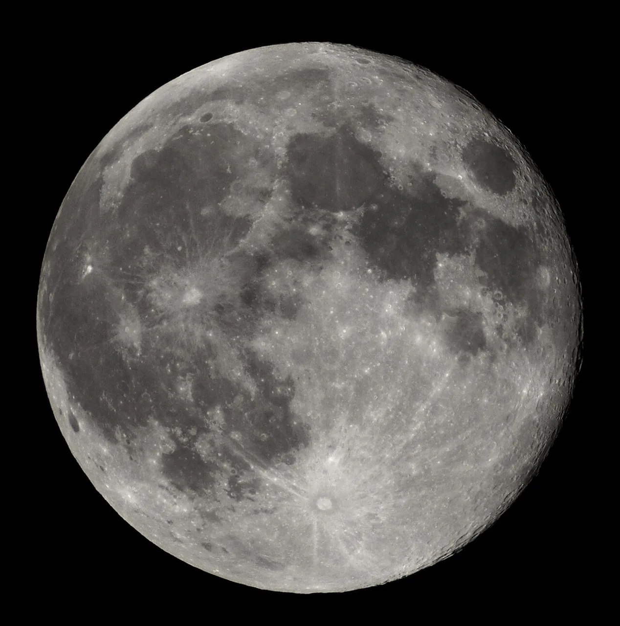 The nearly full Moon, photographed from Earth against a dark sky.
